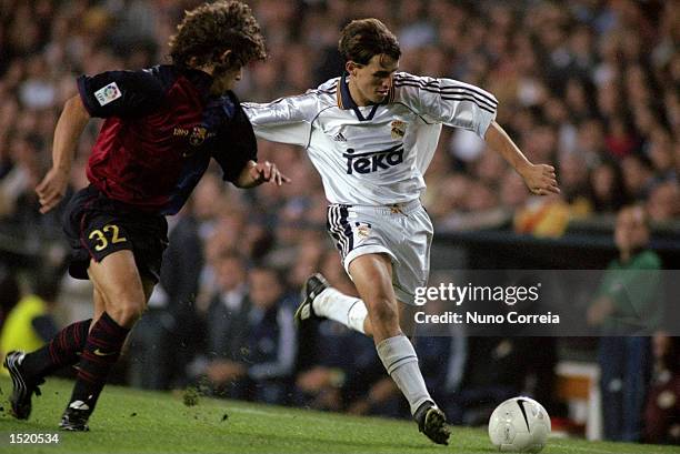 Savio of Real Madrid takes on Carles Puyol of Barcelona during the Spanish Primera Liga match at the Nou Camp in Barcelona, Spain. The game ended...