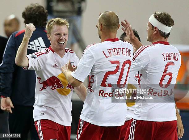 Dax McCarty of the New York Red Bulls celebrates his goal in the second half against the Columbus Crew with teammates Joel Lindpere and Teemu Tainio...