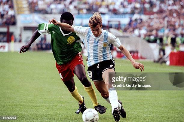 Claudio Caniggia of Argentina is shadowed by Benjamin Massing of Cameroon during the World Cup first round match at the Giuseppe Meazza Stadium in...