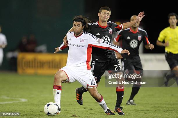 Juan Toja of the New England Revolution controls the ball against Perry Kitchen of D.C. United at RFK Stadium on September 15, 2012 in Washington, DC.