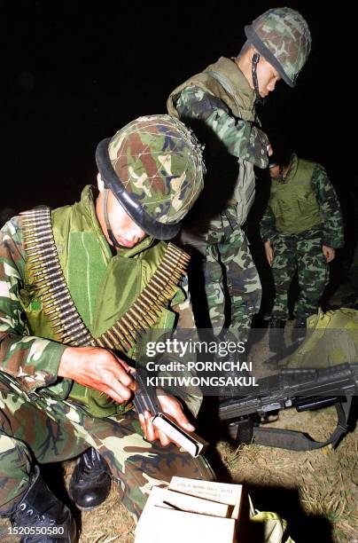 Thai soldiers prepare a machine gun during stand-by at the Thailand-Myanmar border in Mae Sai district on 12 February 2001. Fighting between...