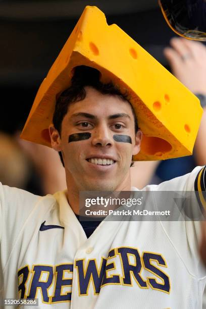 Christian Yelich of the Milwaukee Brewers celebrates in the dugout after hitting a three-run home run against the Chicago Cubs in the fifth inning at...