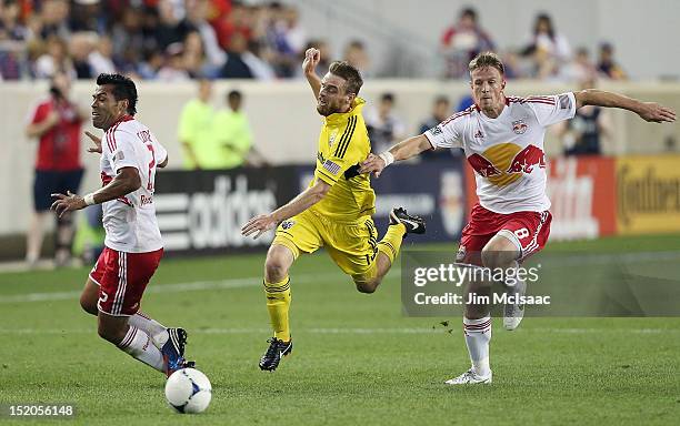 Wilman Conde and Jan Gunnar Solli of the New York Red Bulls defend against Eddie Gaven of the Columbus Crew at Red Bull Arena on September 15, 2012...