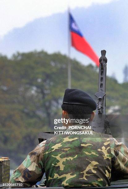 Thai soldier, on an armoured vehicle mounting with a machine gun, patrols the Thai-Myanmar border at Mae Sai checkpoint, 16 February 2001, as the...