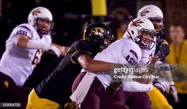 Missouri defensive lineman Brad Madison wraps up Arizona State quarterback Ryan Woods as Woods tried to run the ball after a missed snap during a...
