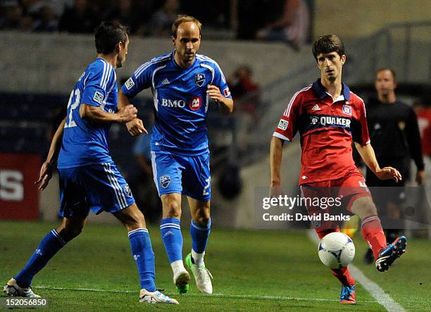 Alvaro Fernandez of the Chicago Fire is defended by Justin Mapp Montreal Impact and Davy Arnaud in an MLS match on September 15, 2012 at Toyota Park...