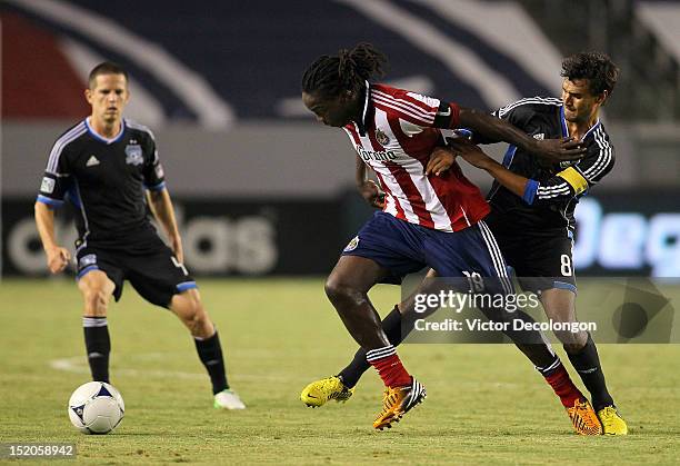 Chris Wondolowski of the San Jose Earthquakes and Shalrie Joseph of Chivas USA vie for position to the ball during the MLS match at The Home Depot...