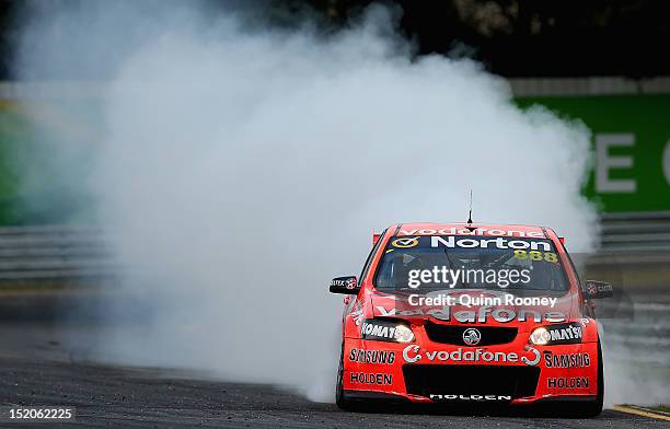 Craig Lowndes driver of the Team Vodafone Holden does a burn out to celebrate winning the Sandown 500, which is round 10 of the V8 Supercars...