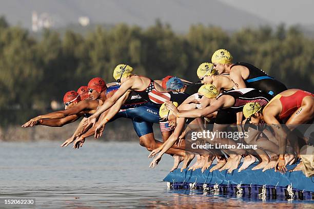 Athletes begin the swimming stage during the 2012 Beijing International Triathlon at Qinglong lake park Fengtai District on September 16, 2012 in...