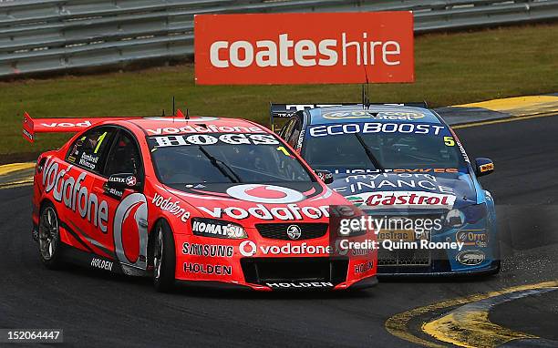 Mark Winterbottom driving the Orrcon Steel FPR Ford passes up the inside of Jamie Whincup driving the Team Vodafone Holden during the Sandown 500,...