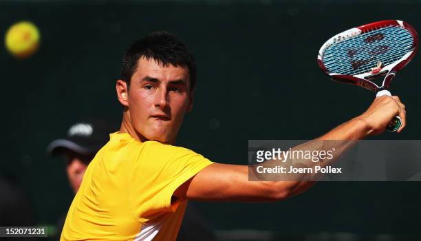 Bernard Tomic of Australia returns the ball to Florian Mayer of Germany during the Davis Cup World Group Play-Off match between Germany and Australia...