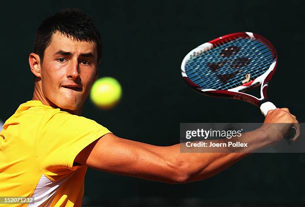 Bernard Tomic of Australia returns the ball to Florian Mayer of Germany during the Davis Cup World Group Play-Off match between Germany and Australia...