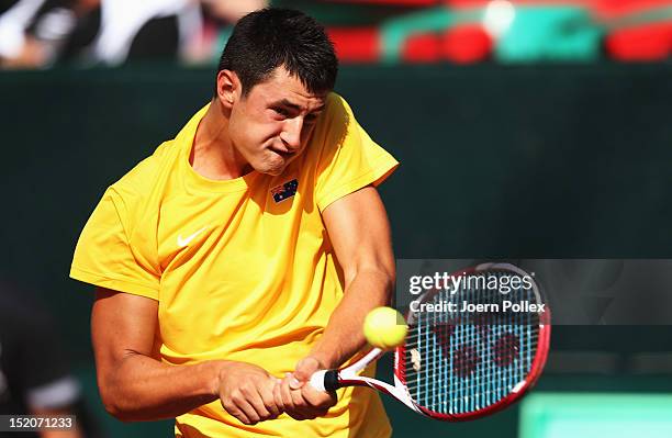 Bernard Tomic of Australia returns the ball to Florian Mayer of Germany during the Davis Cup World Group Play-Off match between Germany and Australia...