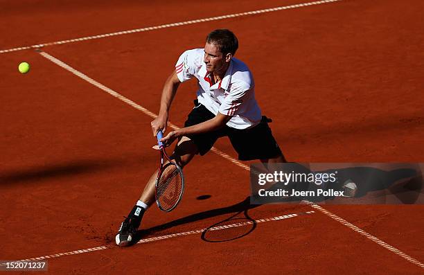 Florian Mayer of Germany returns the ball to Bernard Tomic of Australia during the Davis Cup World Group Play-Off match between Germany and Australia...