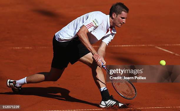 Florian Mayer of Germany returns the ball to Bernard Tomic of Australia during the Davis Cup World Group Play-Off match between Germany and Australia...