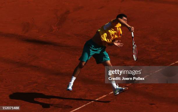 Bernard Tomic of Australia serves the ball to Florian Mayer of Germany during the Davis Cup World Group Play-Off match between Germany and Australia...