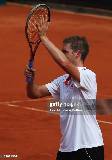 Florian Mayer of Germany celebrates after winning his match against Bernard Tomic of Australia during the Davis Cup World Group Play-Off match...