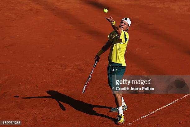 Lleyton Hewit of Australia serves the ball to Cedrik-Marcel Stebe of Germany during the Davis Cup World Group Play-Off match between Germany and...