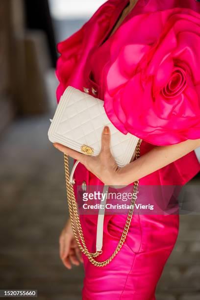Salome Chaboki is seen wearing pink fuchsia satin jacket with pearl buttons and Large 3D rose sleeve details and fuchsia cropped straight leg satin...