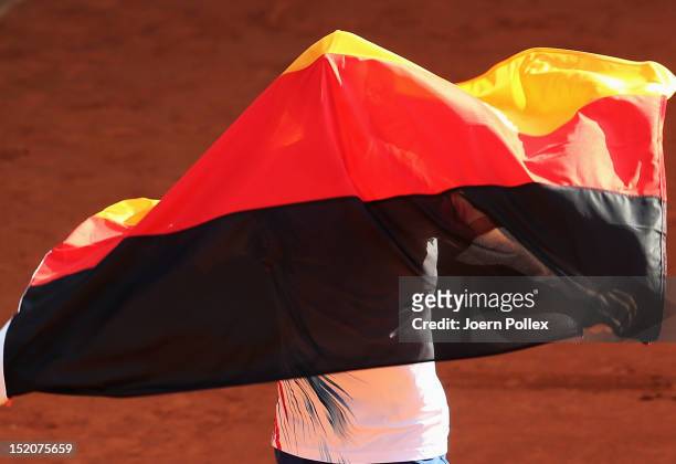 Cedrik-Marcel Stebe of Germany celebrates after winning his match against Lleyton Hewitt of Australia during the Davis Cup World Group Play-Off match...