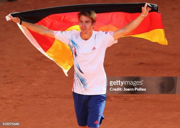 Cedrik-Marcel Stebe of Germany celebrates after winning his match against Lleyton Hewitt of Australia during the Davis Cup World Group Play-Off match...