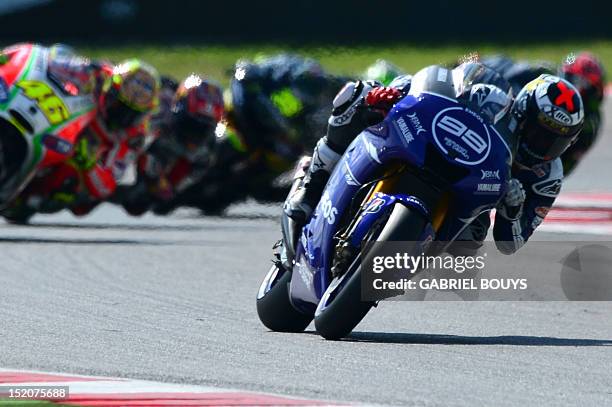 Spanish rider Jorge Lorenzo steers his Yamaha ahead of Italian Valentino Rossi on his Ducati to win the San Marino Moto Grand Prix on September 16,...