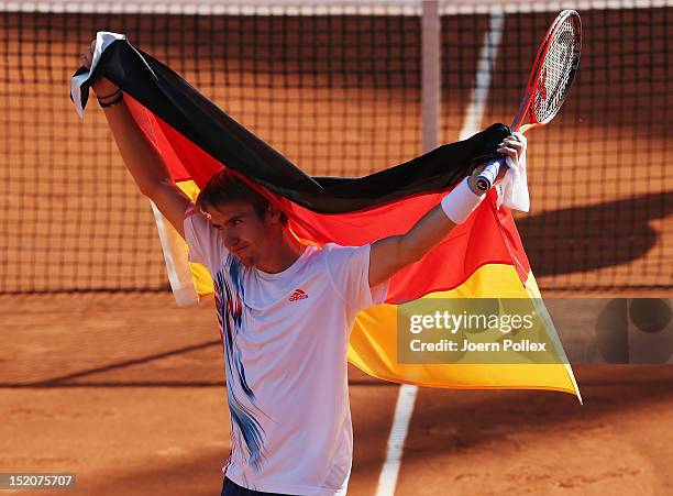 Cedrik-Marcel Stebe of Germany celebrates after winning his match against Lleyton Hewitt of Australia during the Davis Cup World Group Play-Off match...