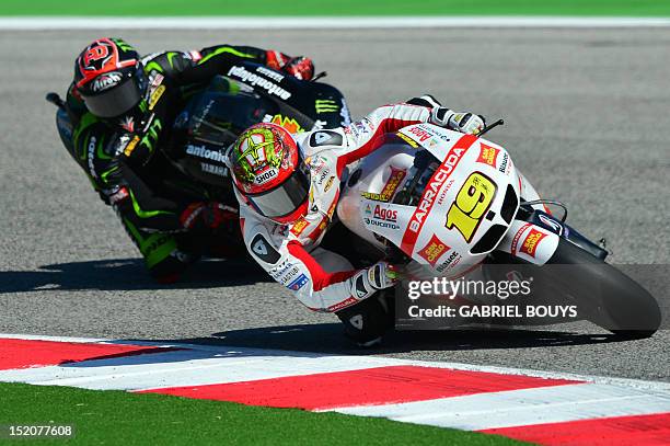 Spanish rider Alvaro Bautista steers his Honda ahead of Italian rider Andrea Dovizioso on Yamaha during the San Marino Moto Grand Prix on September...