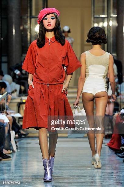 Model showcases designs on the catwalk by Vivienne Westwood Red Label on day 3 of London Fashion Week Spring/Summer 2013, at the British Foreign &...