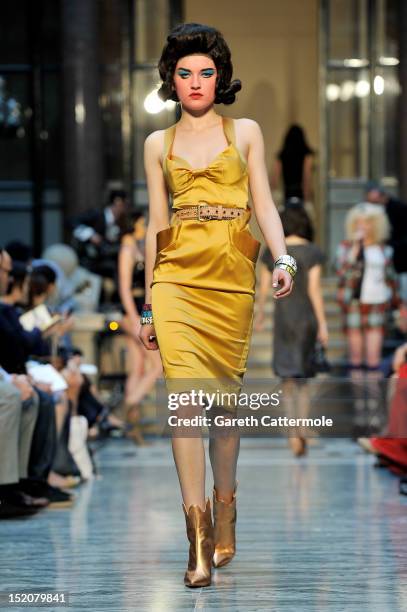 Model showcases designs on the catwalk by Vivienne Westwood Red Label on day 3 of London Fashion Week Spring/Summer 2013, at the British Foreign &...