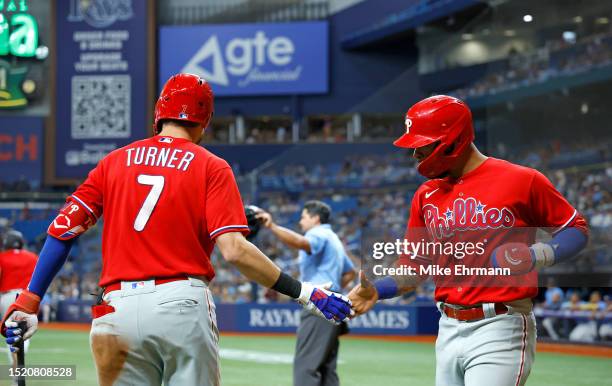 Edmundo Sosa of the Philadelphia Phillies is congratulated after scoring a run eleventh inning during a game against the Tampa Bay Rays at Tropicana...