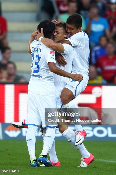 Boris Vukcevic of Hoffenheim celebrates his goal with his teammates Takashi Usami and Roberto Firmino during the Bundesliga match between SC Freiburg...