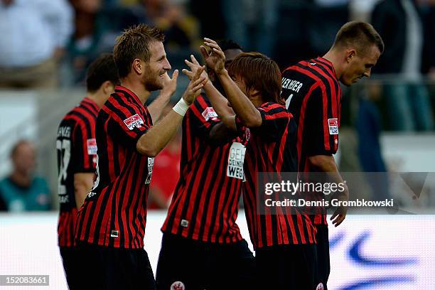 Stefan Aigner of Frankfurt celebrates with teammate Takashi Inui after scoring his team's third goal during the Bundesliga match between Eintracht...