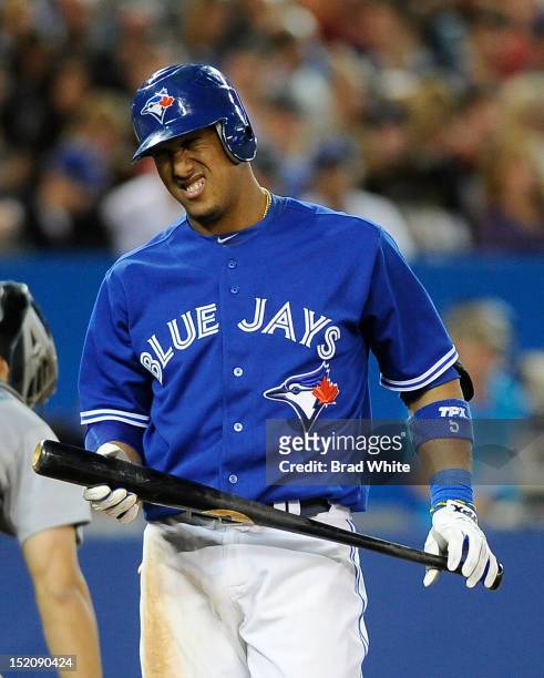 Yunel Escobar of the Toronto Blue Jays winces in pain during MLB game action against the Seattle Mariners September 11, 2012 at Rogers Centre in...