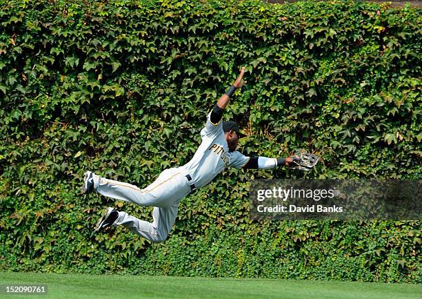 Starling Marte of the Pittsburgh Pirates tries to make a diving catch on a Anthony Rizzo of the Chicago Cubs double in the first inning on September...