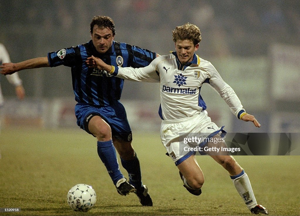 Jesper Blomqvist of Parma AC and Giovanni Pinchentini of Atalanta Bergamasca Calcio