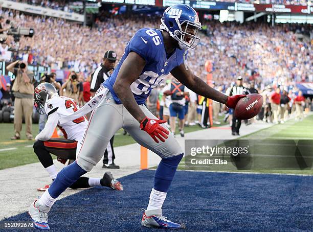 Martellus Bennett of the New York Giants celebrates his touchdown in the fourth quarter as Brandon McDonald of the Tampa Bay Buccaneers reacts on...