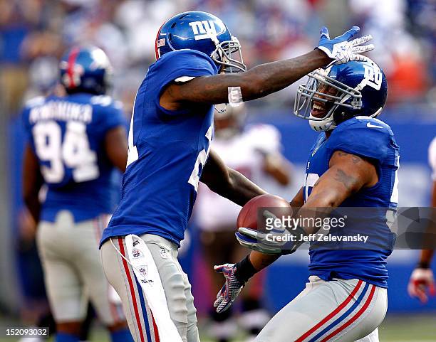 Michael Boley and Kenny Phillips of the New York Giants celebrate Boleys interception during a game against the Tampa Bay Buccaneers at MetLife...