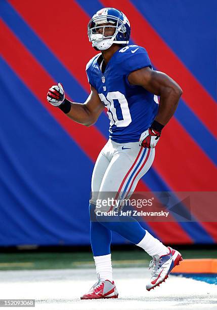 Victor Cruz of the New York Giants celebrates a touchdown with his signature salsa dance during a game against the Tampa Bay Buccaneers at MetLife...