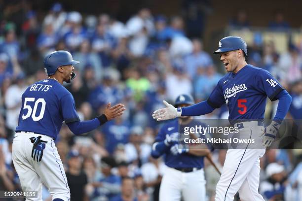 Freddie Freeman of the Los Angeles Dodgers celebrates with teammate Mookie Betts after hitting a two-run home run against the Pittsburgh Pirates...