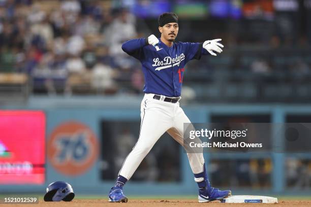Miguel Vargas of the Los Angeles Dodgers reacts after sliding into second base safely against the Pittsburgh Pirates during the fifth inning at...