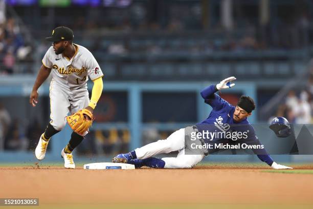 Miguel Vargas of the Los Angeles Dodgers slides into second base safely against Rodolfo Castro of the Pittsburgh Pirates during the fifth inning at...
