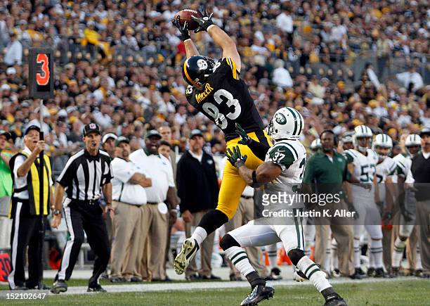 Heath Miller of the Pittsburgh Steelers makes a catch against Yeremiah Bell of the New York Jets during the game on September 16, 2012 at Heinz Field...