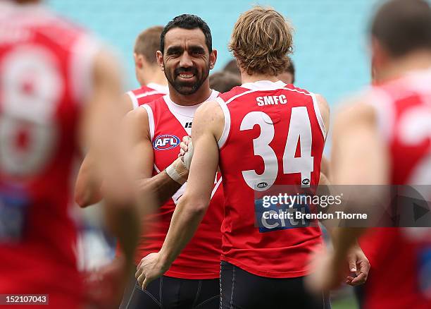 Adam Goodes of the Swans shares a joke with team mate Alex Johnson during a Sydney Swans AFL training session at ANZ Stadium on September 17, 2012 in...