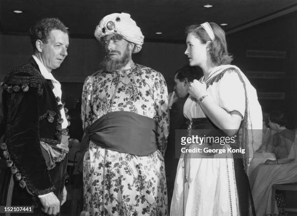 English composer Benjamin Britten with George Lascelles, 7th Earl of Harewood and Mrs Anthony Lyttleton at an opera-themed fancy-dress ball at the...