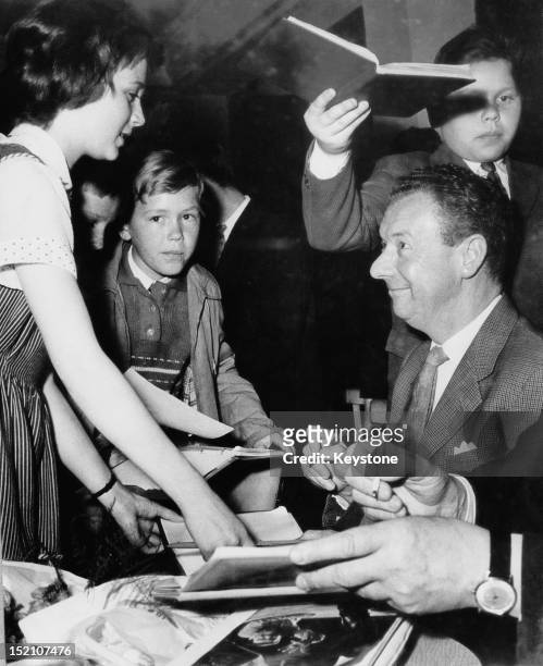 English composer Benjamin Britten signs autographs for children at a young peoples' music convention in Budapest, 23rd April 1964. Britten is guest...