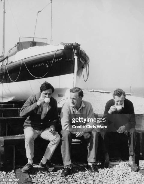 Choreographer John Cranko , operatic tenor Peter Pears and composer Benjamin Britten taking tea on the beach at Aldeburgh, Suffolk, 7th June 1960....