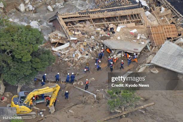 Photo taken from a Kyodo News helicopter shows a search and rescue operation continuing at the site of a mudslide in Karatsu in Saga Prefecture,...