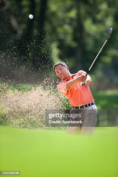 golfer hitting golf ball in sand hazard - golf bunker 個照片及圖片檔