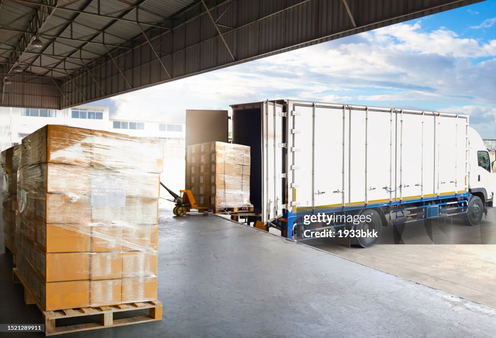Container Trucks Parked Loading Package Boxes Pallets at Warehouse Dock. Supply Chain, Distribution Warehouse Shipping, Supplies Shipment Boxes. Freight Truck Logistic, Cargo Transport.
